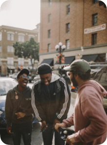 Friends gathered on a city sidewalk, representing a shared memory