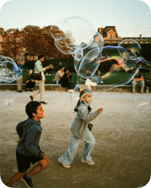 People making giant bubbles outdoors, representing a playful memory